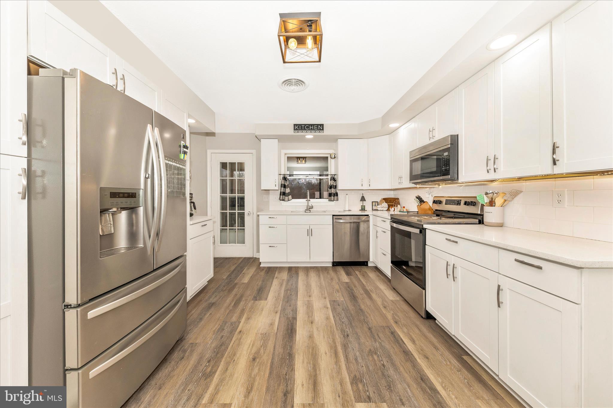 126 Game Trail Road Falling Waters, WV 25419 - Photo 10 of 41 a kitchen with stainless steel appliances granite countertop a refrigerator a stove and a sink