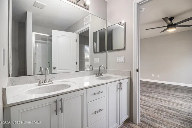 a bathroom with a double vanity sink and mirror