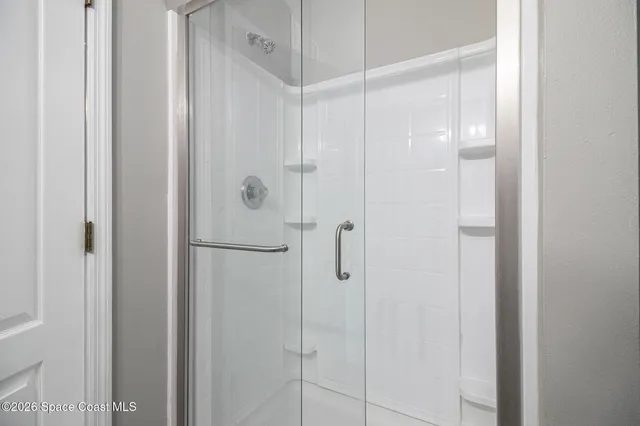 a bathroom with a glass shower door