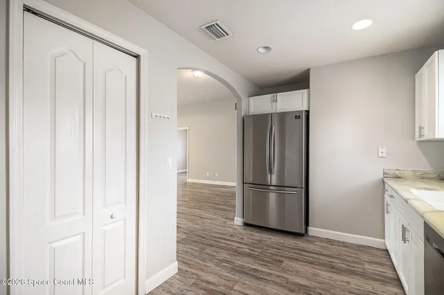 a kitchen with stainless steel appliances granite countertop a refrigerator and a sink