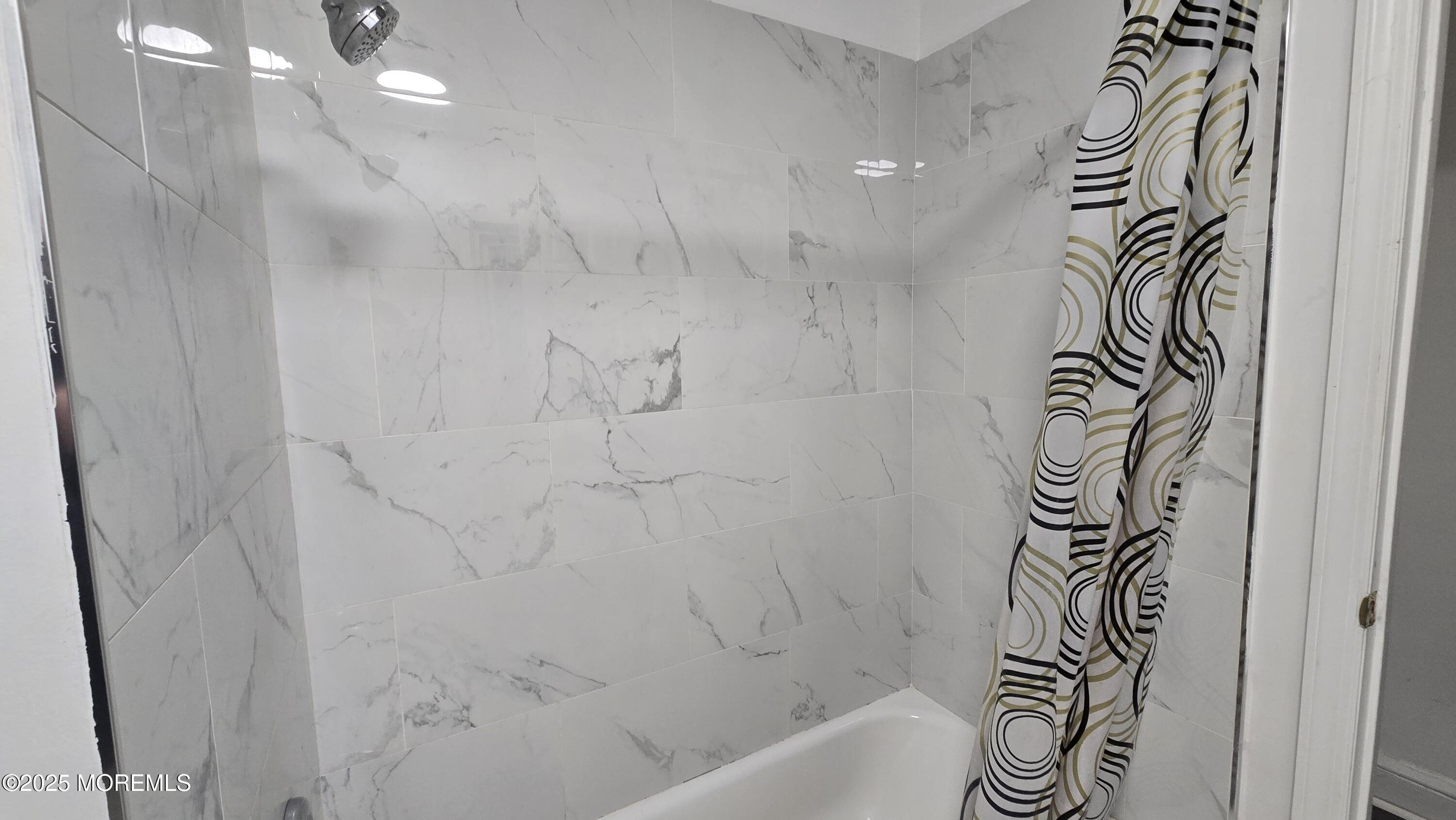 1219 Mattison Avenue, Unit 2 Asbury Park, NJ 07712 - Photo 11 of 11 a bathroom with a bathtub and shower