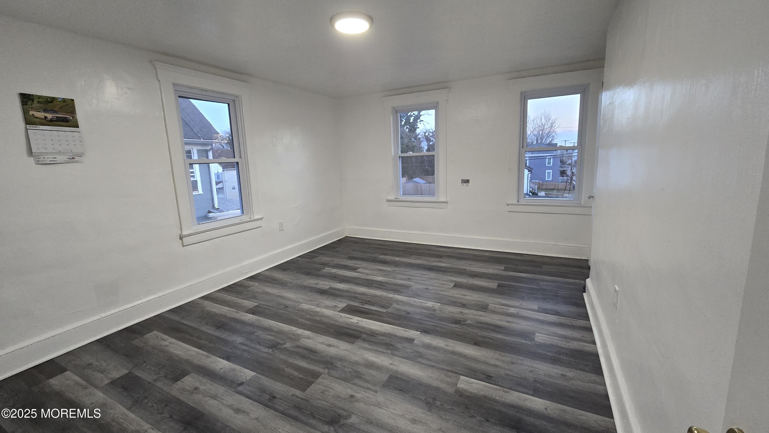 1219 Mattison Avenue, Unit 2 Asbury Park, NJ 07712 - Photo 3 of 11 wooden floor in an empty room with a window
