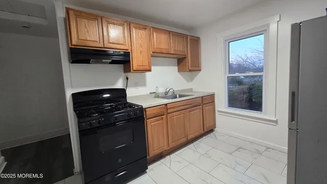 a kitchen with a stove and a refrigerator