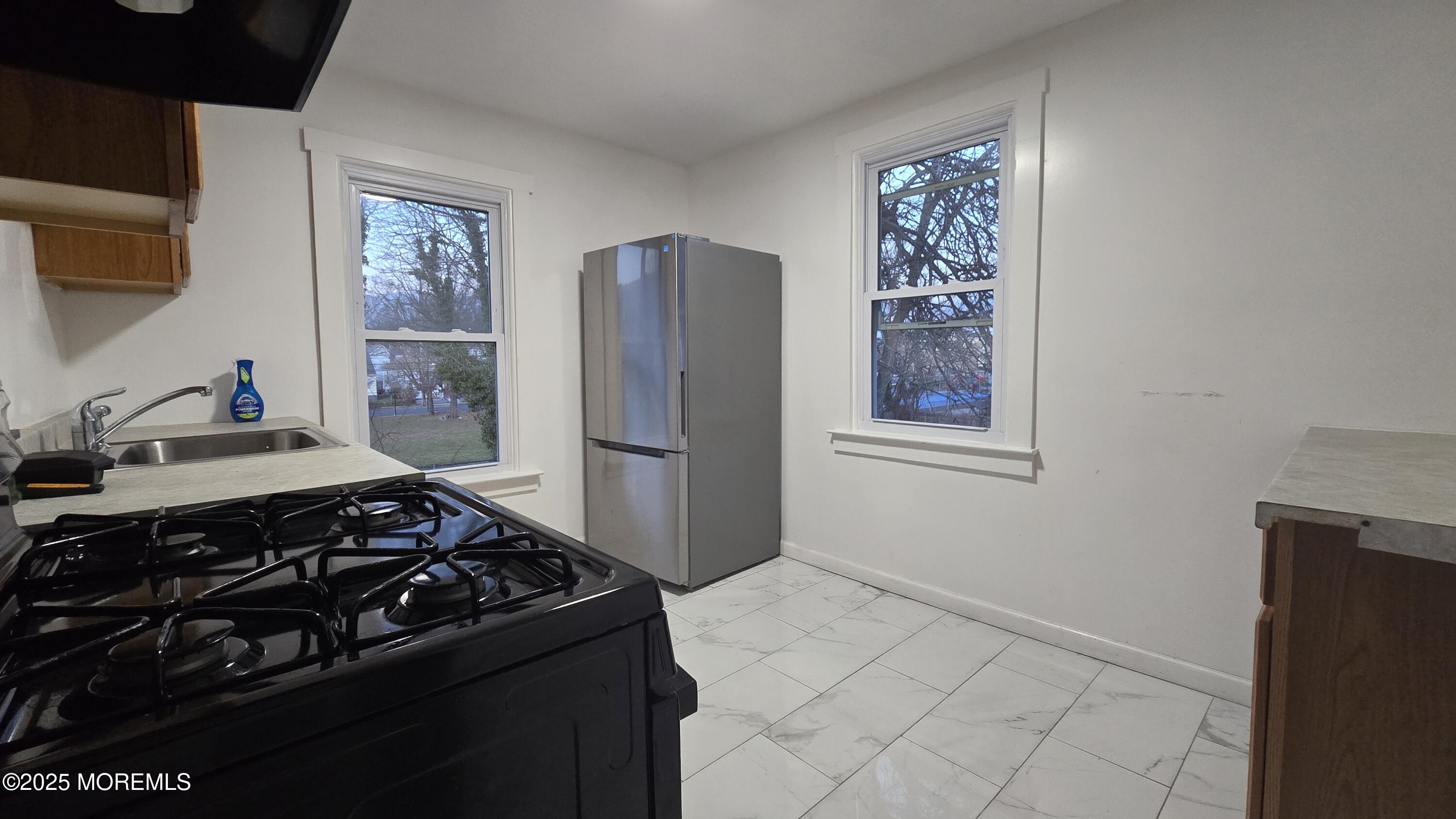 1219 Mattison Avenue, Unit 2 Asbury Park, NJ 07712 - Photo 7 of 11 a kitchen with a stove and a refrigerator