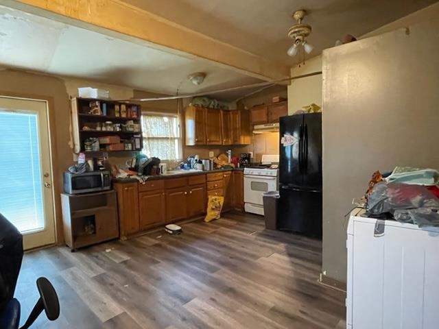 1102 1st Avenue Rochelle, IL 61068 - Photo 4 of 19 a kitchen with refrigerator a microwave a dining table and chairs
