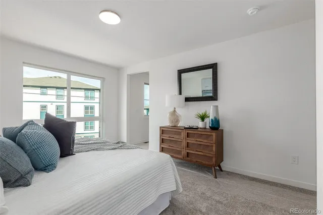 a bedroom with a bed and ceiling fan