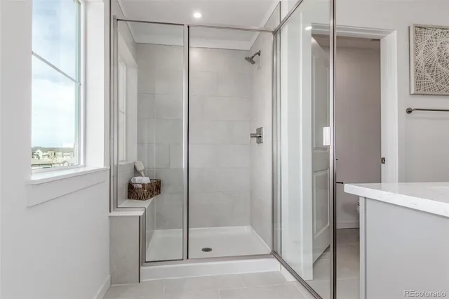 a bathroom with a sink a mirror and a shower