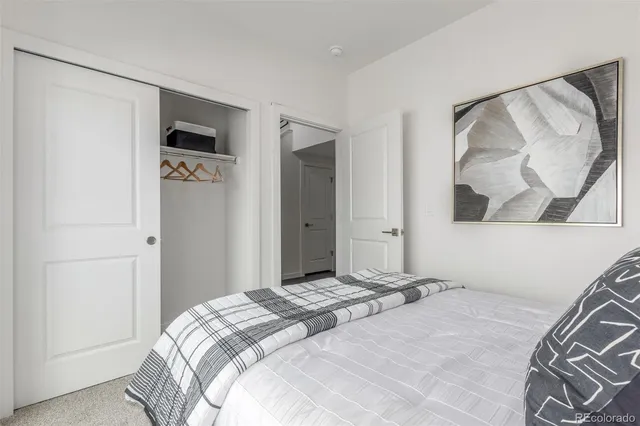 a bathroom with a sink a toilet a mirror and shower curtain