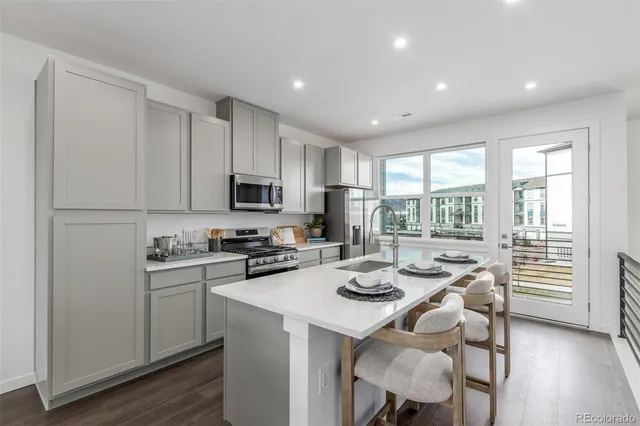 a kitchen with refrigerator and cabinets