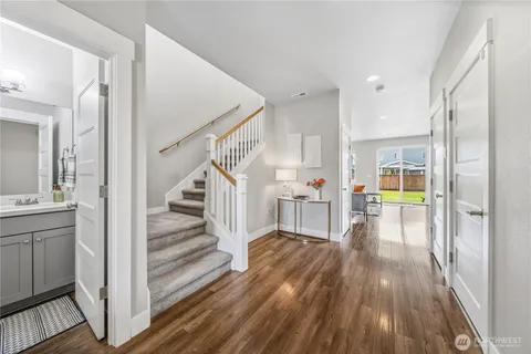 a view of a hallway view with wooden floor and staircase