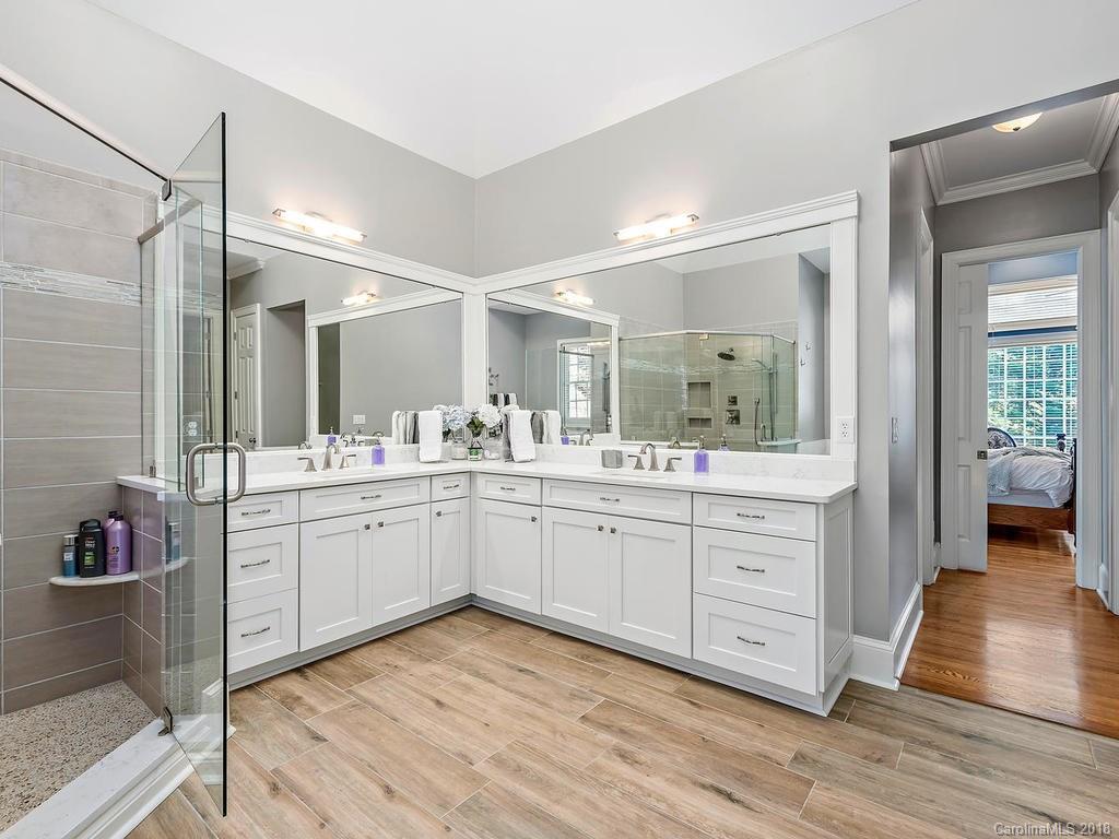 2001 Streamview Court Marvin, NC 28173 - Photo 20 of 35 a spacious bathroom with a granite countertop sink mirror and vanity
