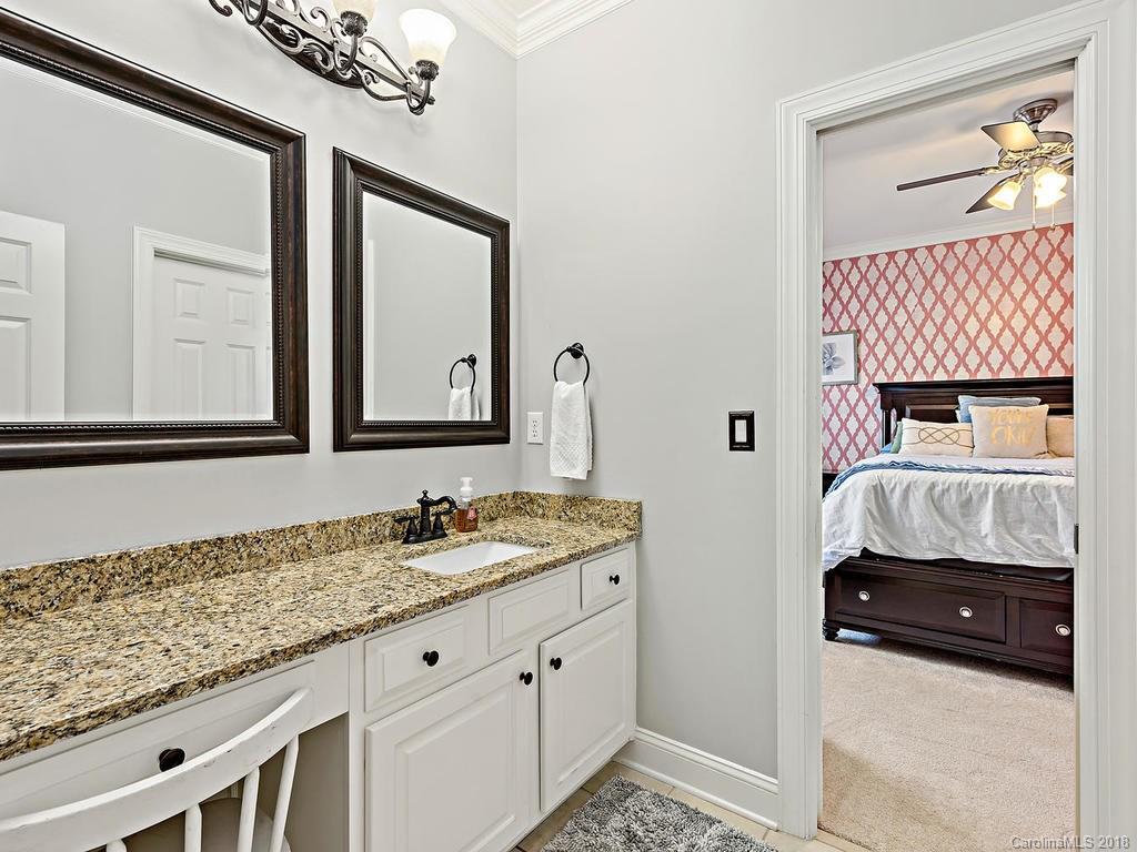 2001 Streamview Court Marvin, NC 28173 - Photo 22 of 35 a en suite bathroom with a granite countertop sink and a mirror