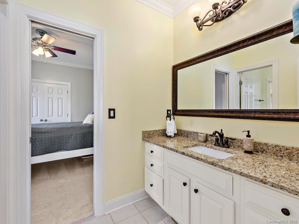 2001 Streamview Court Marvin, NC 28173 - Photo 24 of 35 a en suite bathroom with a granite countertop sink and a mirror