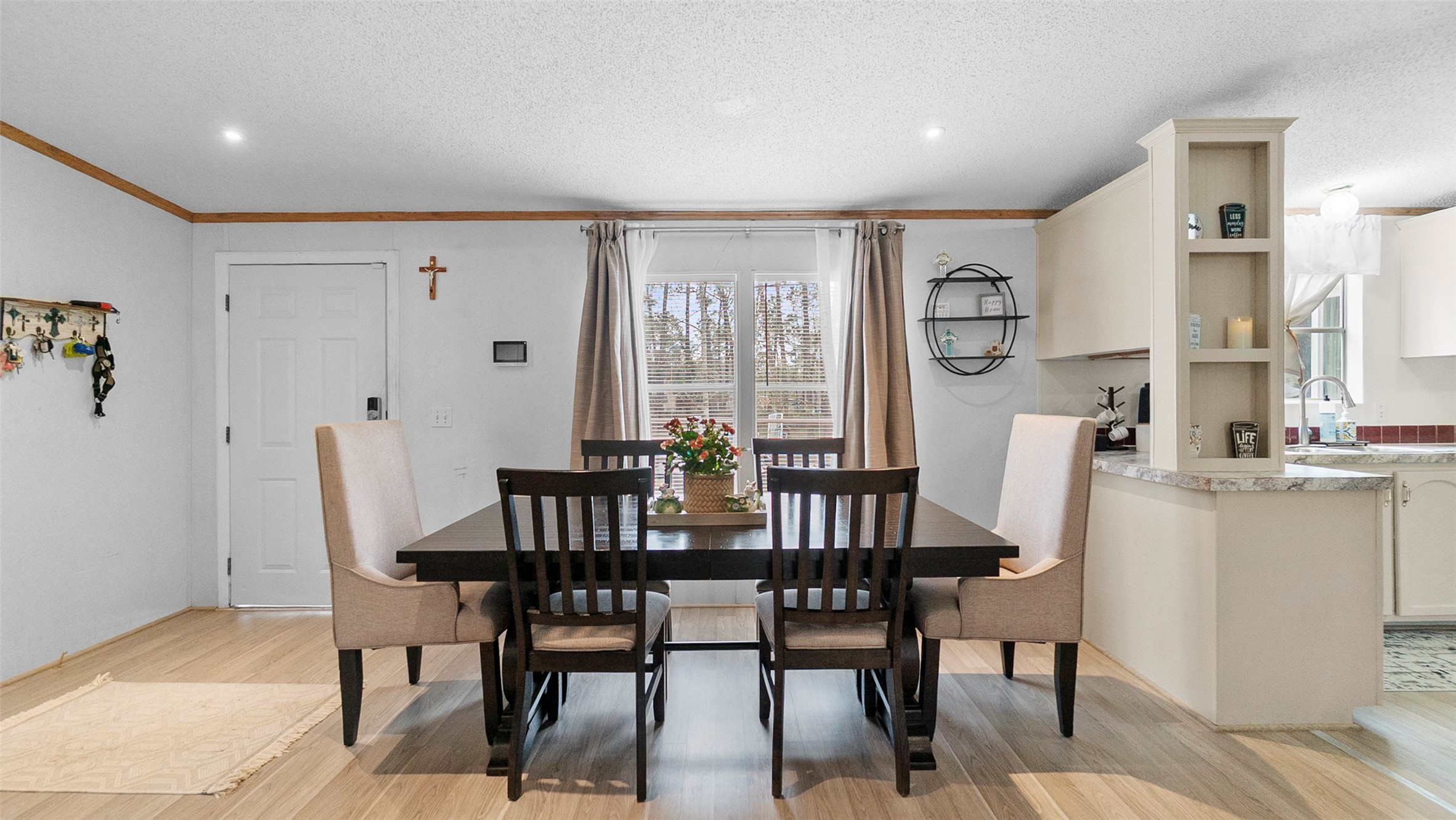 7735 North Walker Road Cleveland, TX 77328 - Photo 12 of 42 a view of a a dining room with furniture window and wooden floor