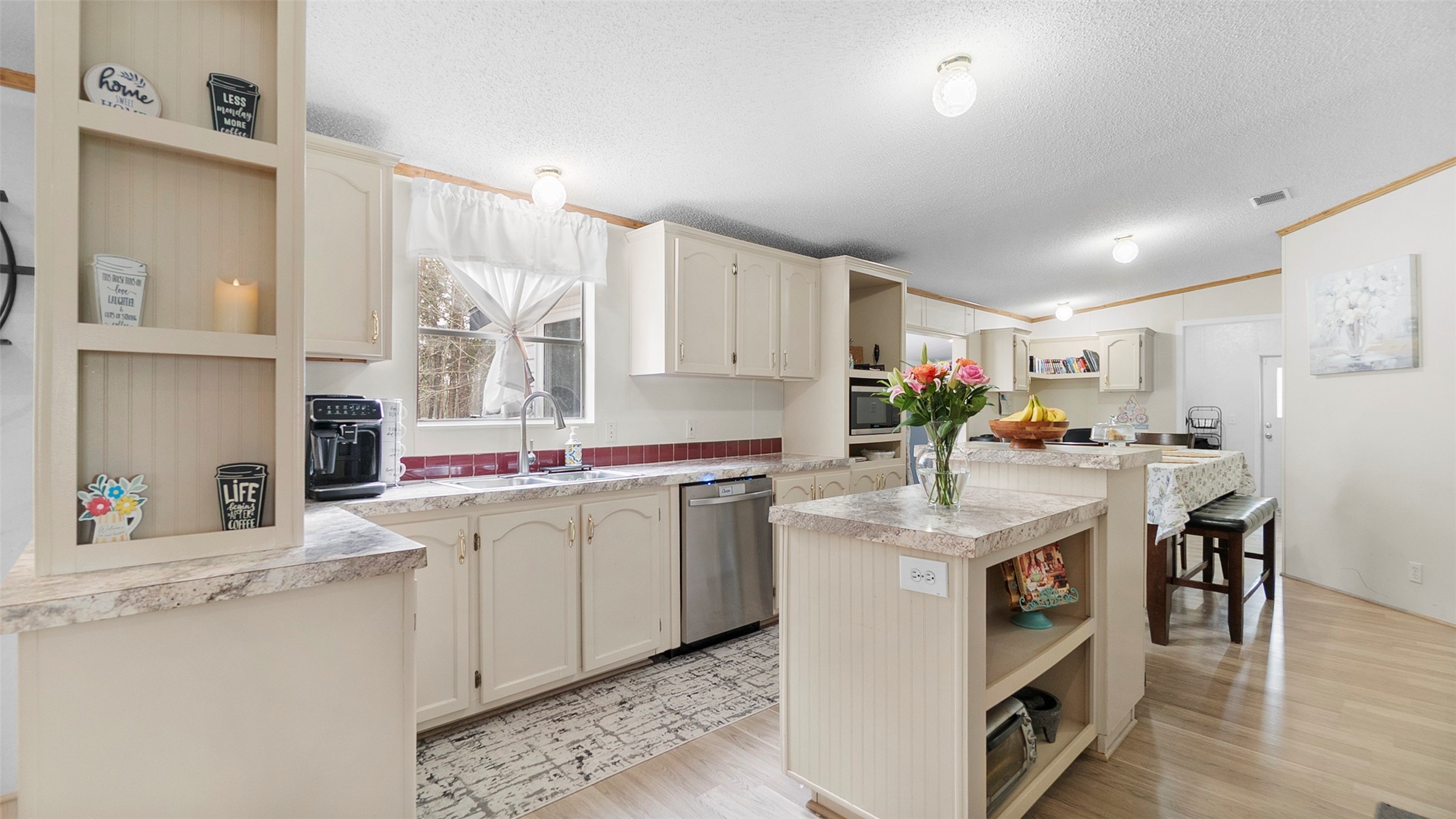 7735 North Walker Road Cleveland, TX 77328 - Photo 13 of 42 a kitchen with a sink stove and cabinets