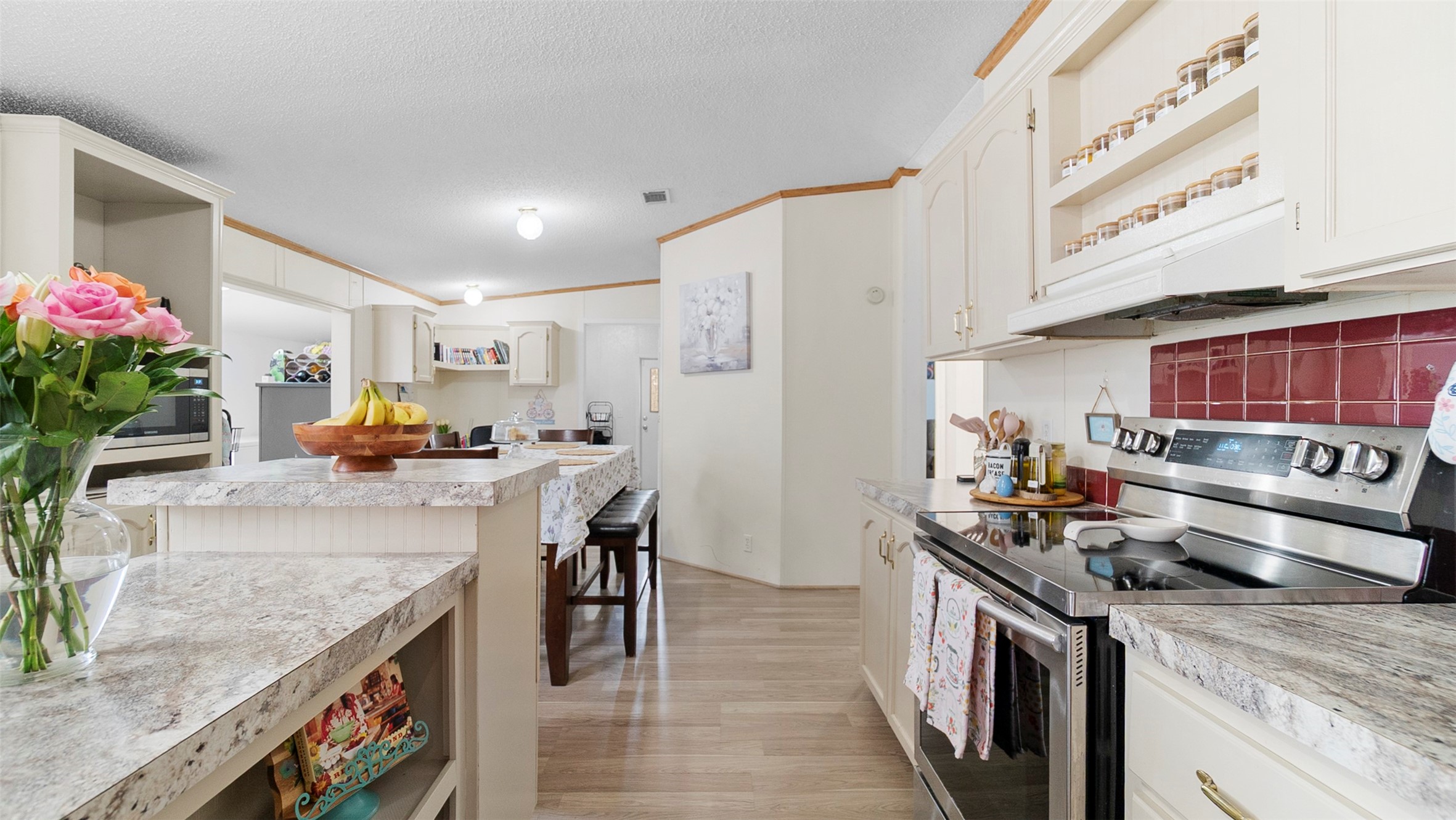 7735 North Walker Road Cleveland, TX 77328 - Photo 15 of 42 a kitchen with a stove and cabinets