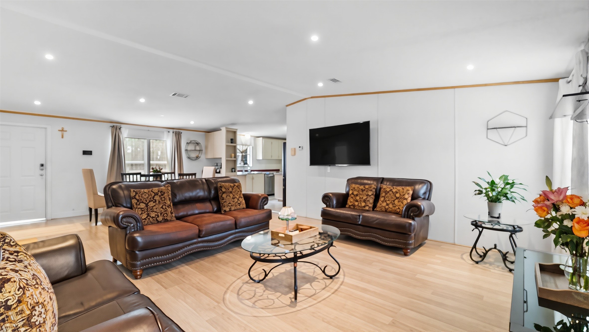 7735 North Walker Road Cleveland, TX 77328 - Photo 24 of 42 a living room with furniture a flat screen tv and a potted plant