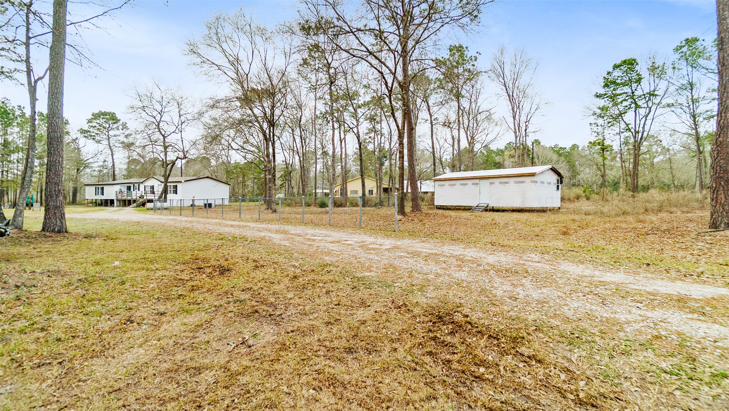 7735 North Walker Road Cleveland, TX 77328 - Photo 7 of 42 a view of a yard with yellow house