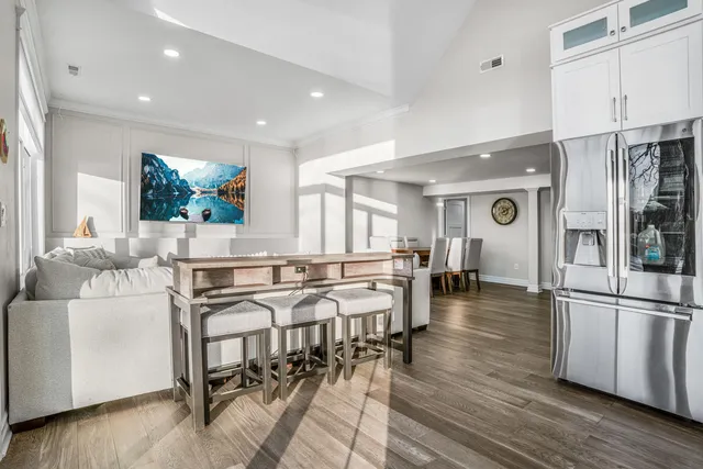 a kitchen with a refrigerator a sink and white cabinets