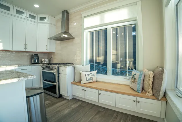 a kitchen with stainless steel appliances granite countertop a sink a stove and a refrigerator