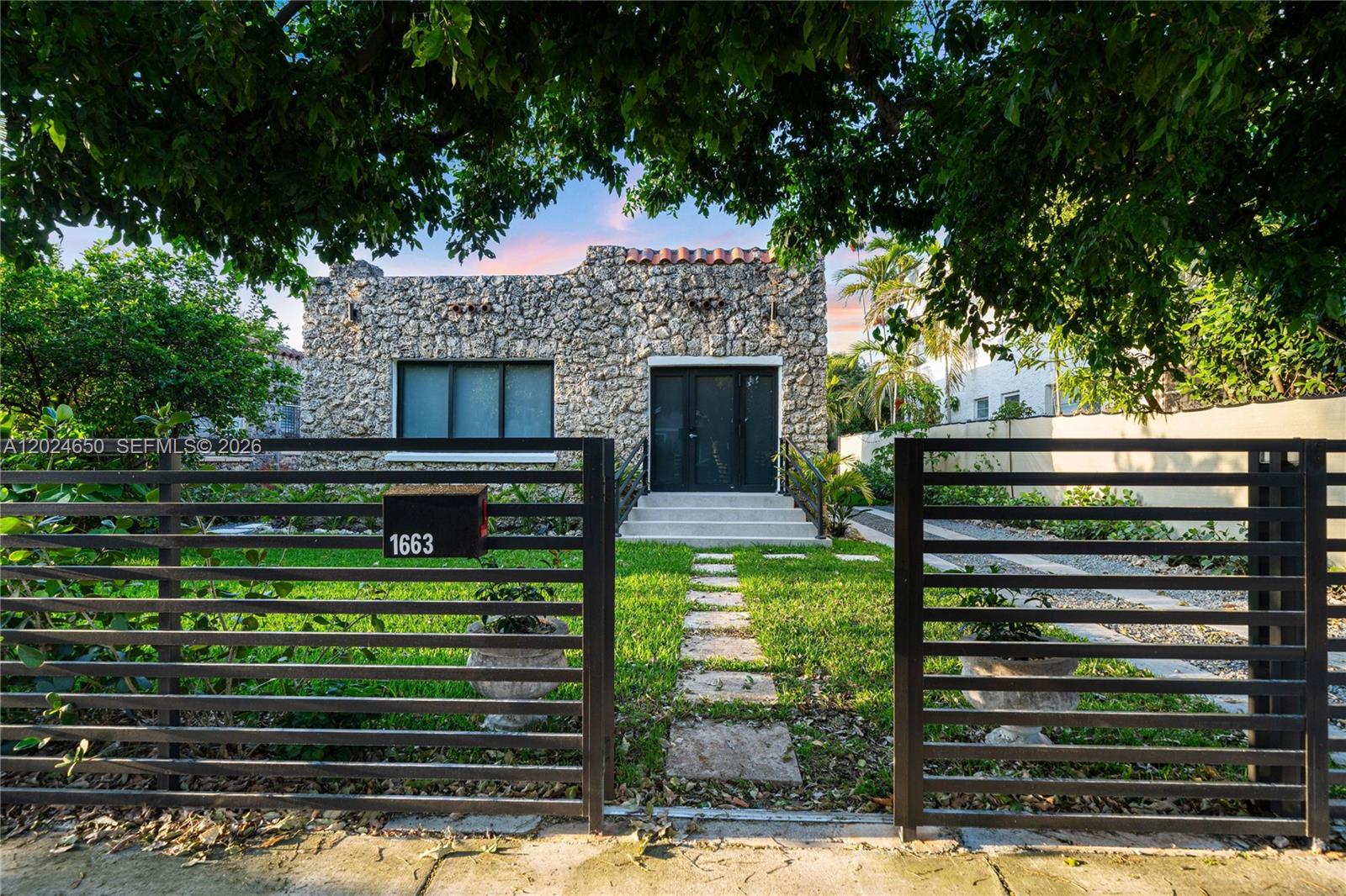 1663 Southwest 13th Street Miami, FL 33145 - Photo 2 of 112 a front view of a house with a garden