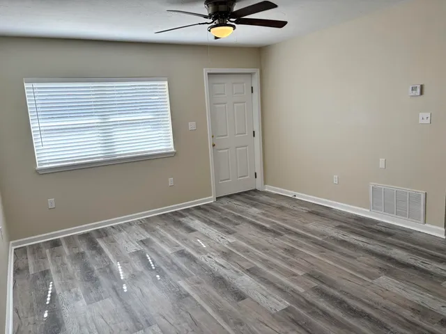 a view of room with window and ceiling fan