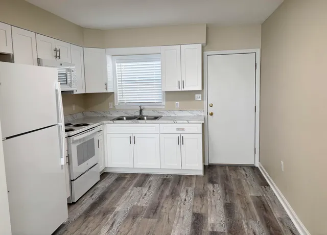 a kitchen with a white cabinets and white appliances