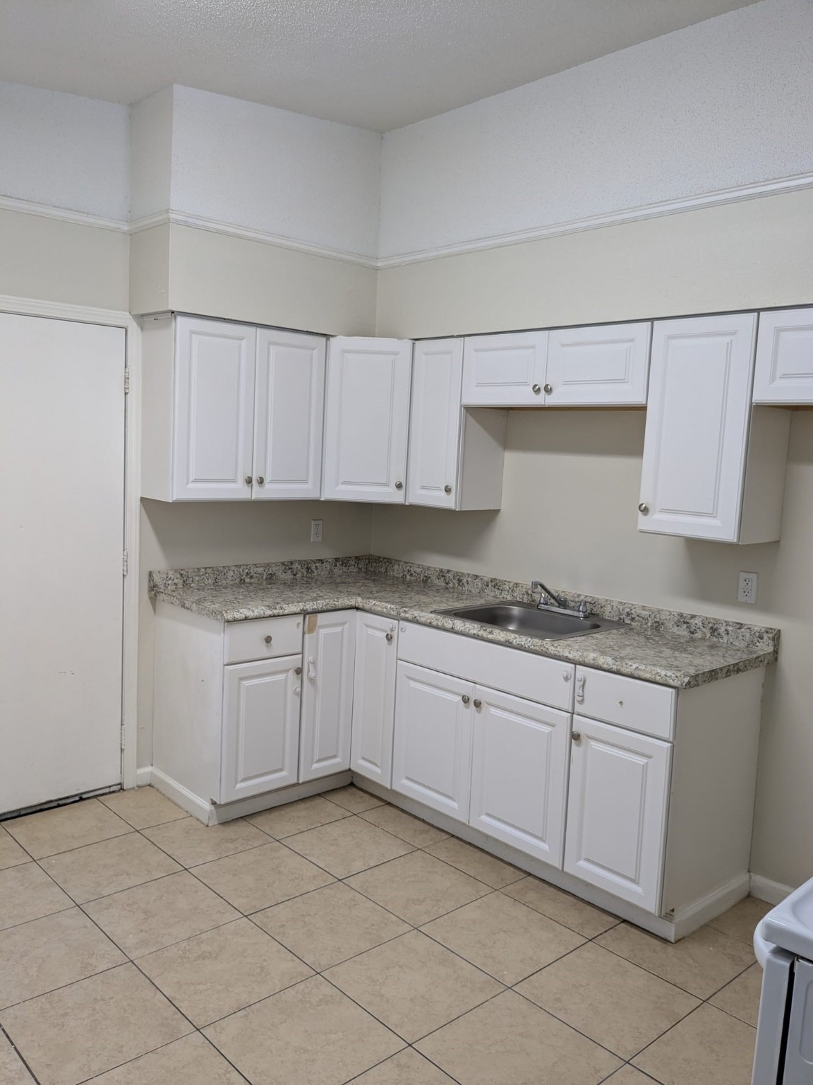 3359 Frick Road, Unit 6 Houston, TX 77086 - Photo 5 of 10 a kitchen with granite countertop a sink and cabinets