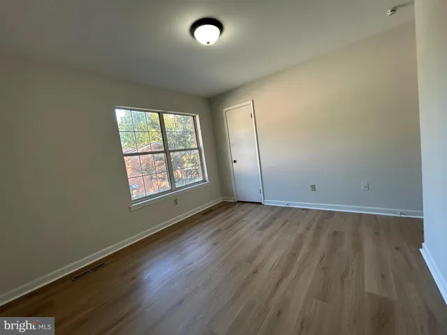an empty room with wooden floor