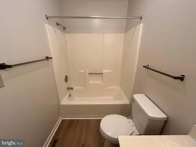 a toilet sitting in a bathroom next to a sink