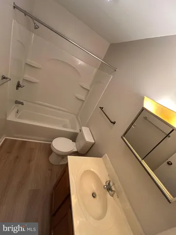 a bathroom with a sink mirror and toilet