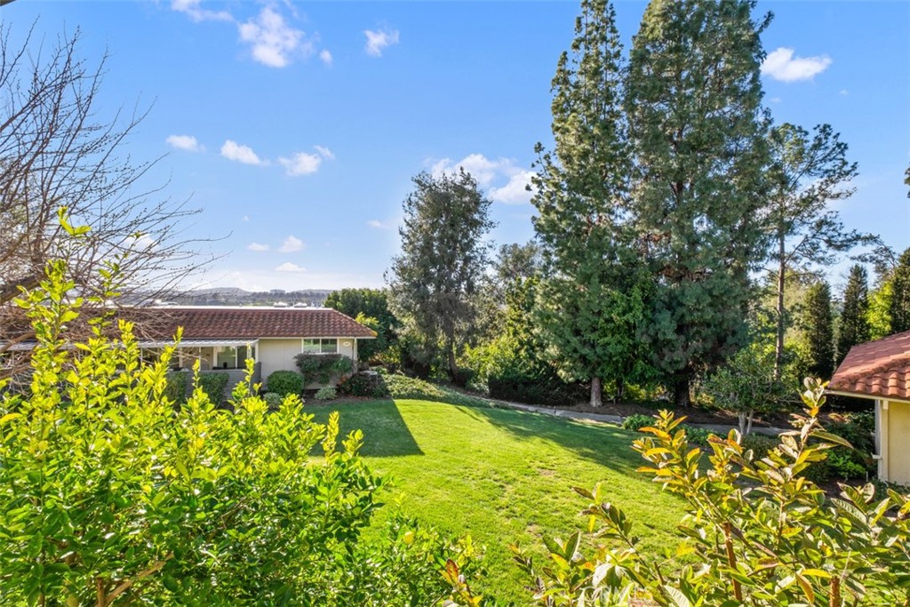 842 Ronda Sevilla, Unit B Laguna Woods, CA 92637 - Photo 1 of 27 a view of a swimming pool with a yard