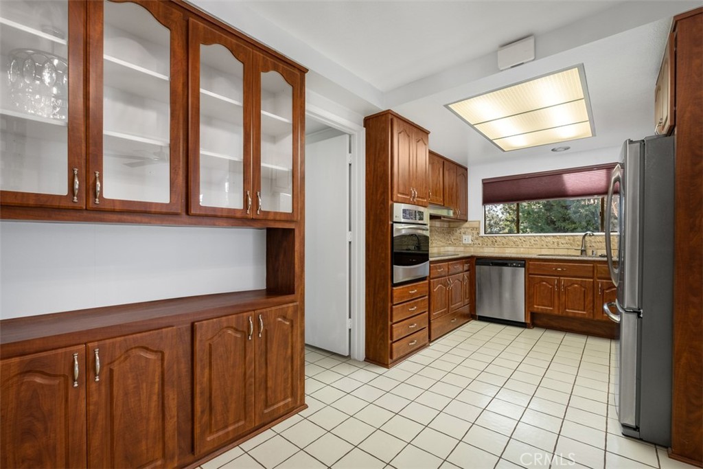 842 Ronda Sevilla, Unit B Laguna Woods, CA 92637 - Photo 6 of 27 a kitchen with stainless steel appliances a refrigerator and cabinets