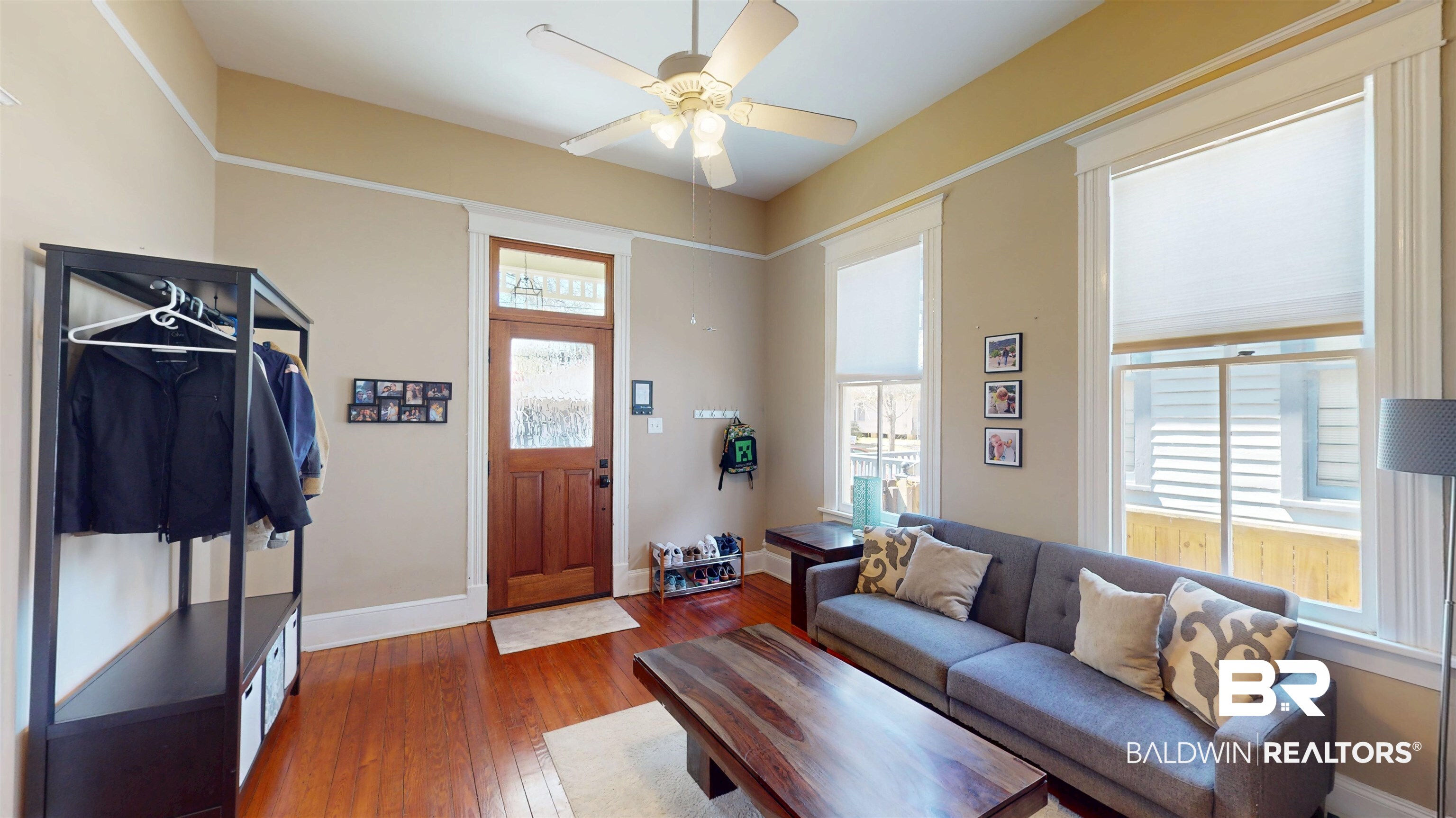 1154 New St Francis Street Mobile, AL 36604 - Photo 10 of 37 Living room with a wealth of natural light, baseboards, ceiling fan, and dark wood-style flooring