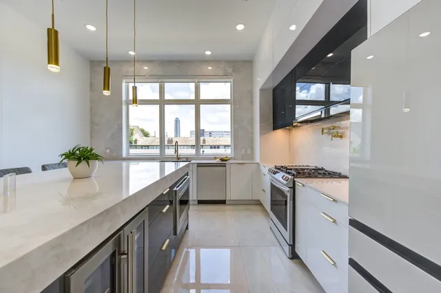 a kitchen with a refrigerator and a sink