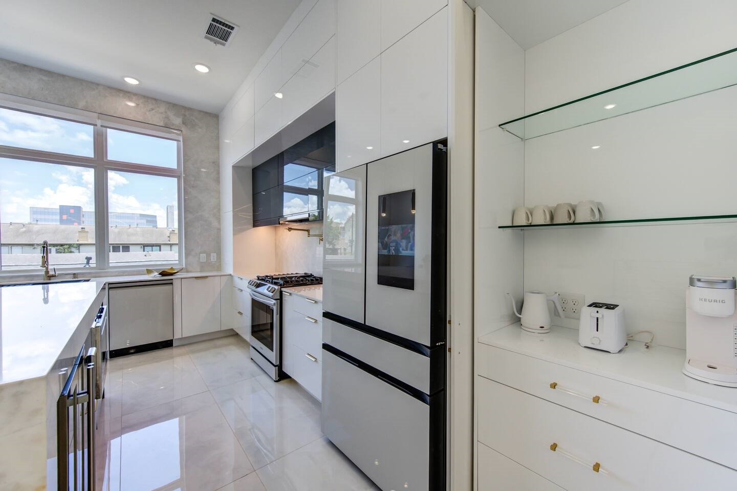 5702 Fairdale Lane, Unit C Houston, TX 77057 - Photo 13 of 47 a kitchen with a refrigerator and a sink