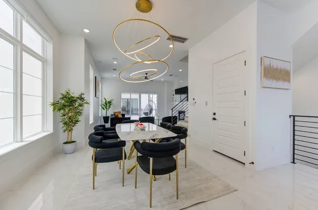 a dinning room with kitchen island furniture and a large window