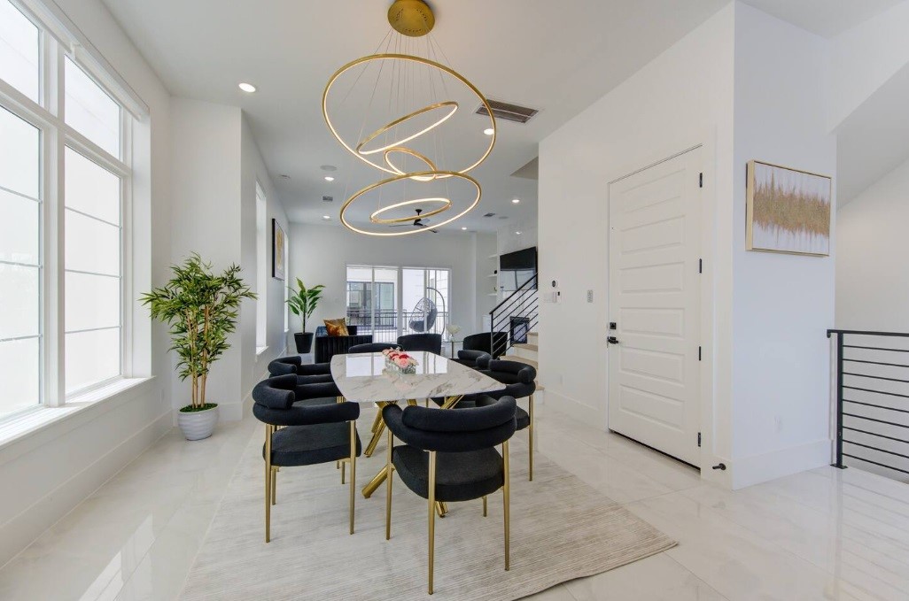 5702 Fairdale Lane, Unit C Houston, TX 77057 - Photo 14 of 47 a kitchen with stainless steel appliances a table and chairs in it