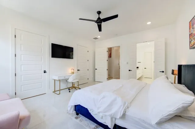 a spacious bathroom with a double vanity sink large mirror and a bathtub