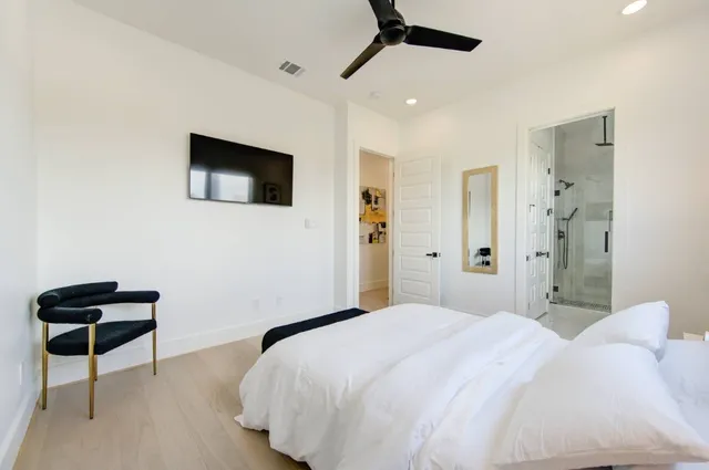 a bedroom with a bed and a chair