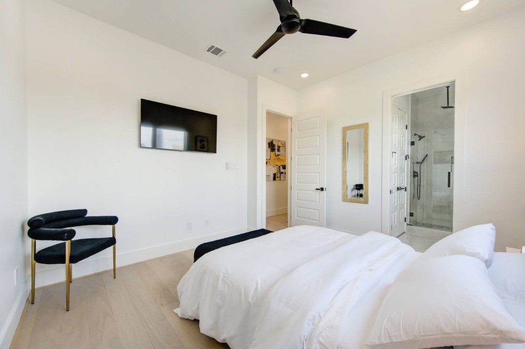 5702 Fairdale Lane, Unit C Houston, TX 77057 - Photo 31 of 47 a bedroom with a bed and a mirror