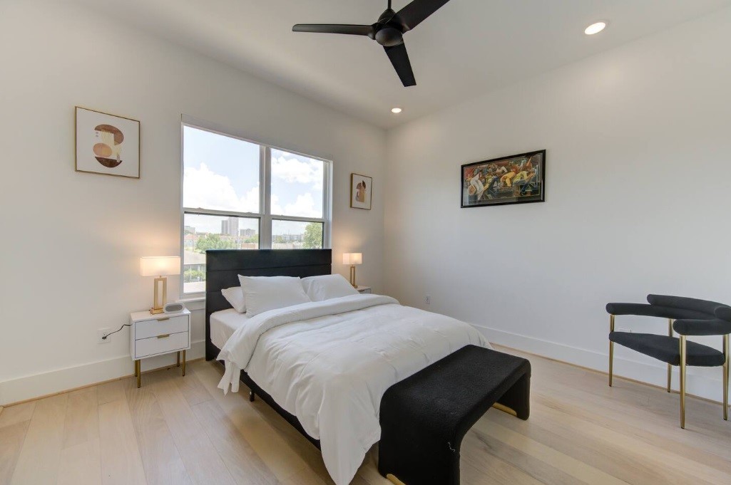 5702 Fairdale Lane, Unit C Houston, TX 77057 - Photo 32 of 47 a bedroom with a bed and a chair