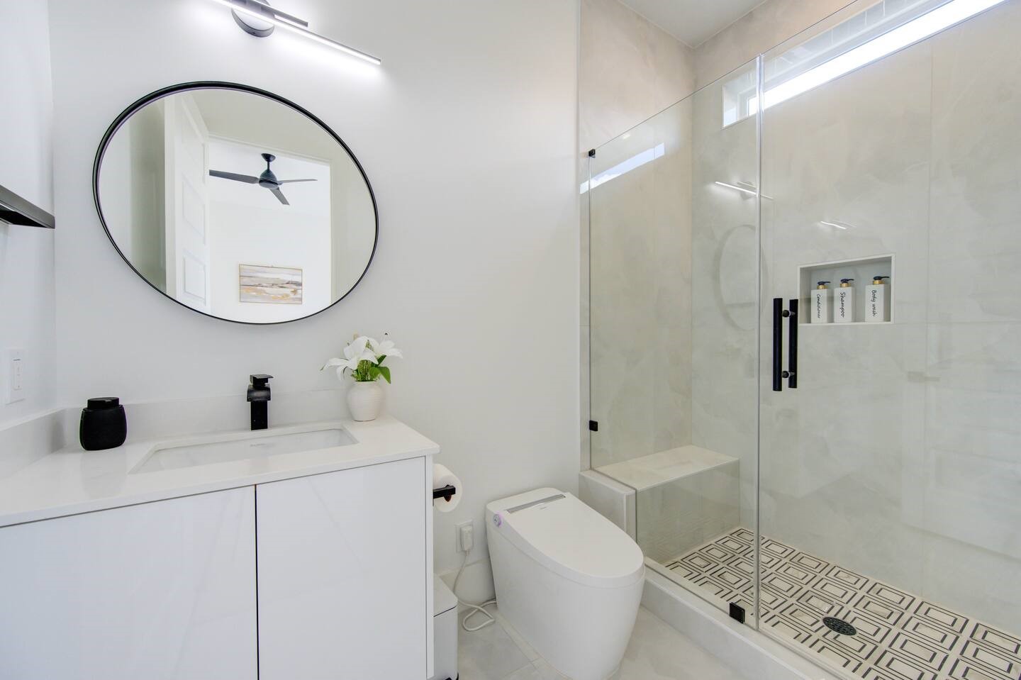 5702 Fairdale Lane, Unit C Houston, TX 77057 - Photo 34 of 47 a bathroom with a toilet a sink a mirror and shower