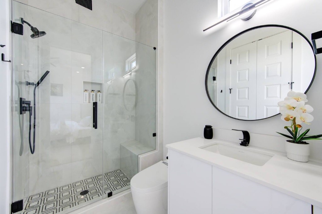 5702 Fairdale Lane, Unit C Houston, TX 77057 - Photo 35 of 47 a bathroom with a sink a toilet and a mirror