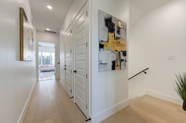 a living room with furniture kitchen view and a chandelier