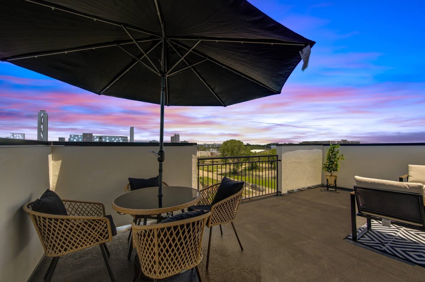5702 Fairdale Lane, Unit C Houston, TX 77057 - Photo 46 of 47 a patio with a table and chairs under an umbrella