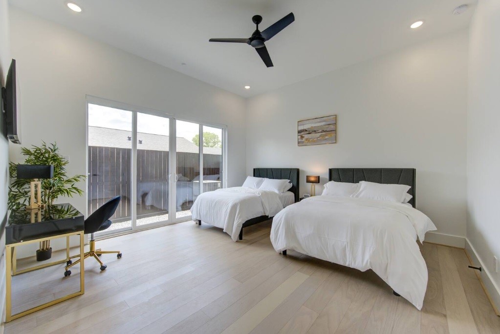 5702 Fairdale Lane, Unit C Houston, TX 77057 - Photo 7 of 47 a spacious bedroom with two beds and potted plant