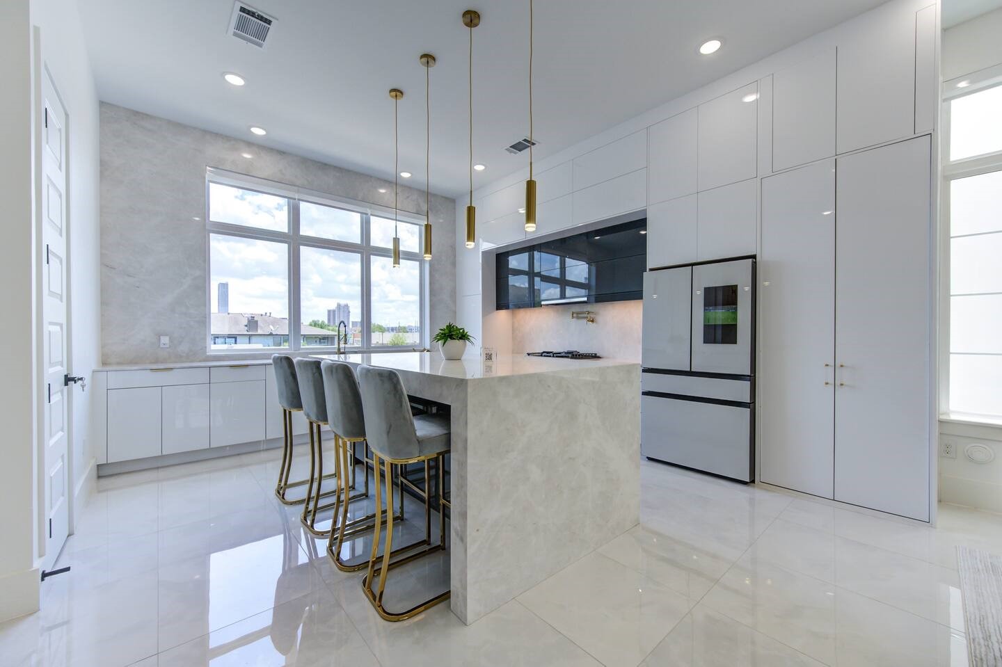 5702 Fairdale Lane, Unit C Houston, TX 77057 - Photo 10 of 47 a kitchen with stainless steel appliances kitchen island granite countertop a table chairs and a refrigerator