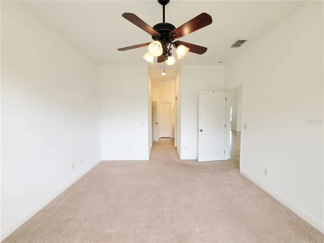 en empty room with fan and window