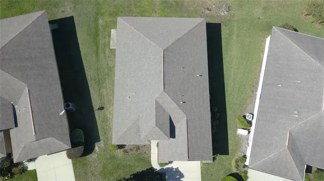 an aerial view of houses with a swimming pool